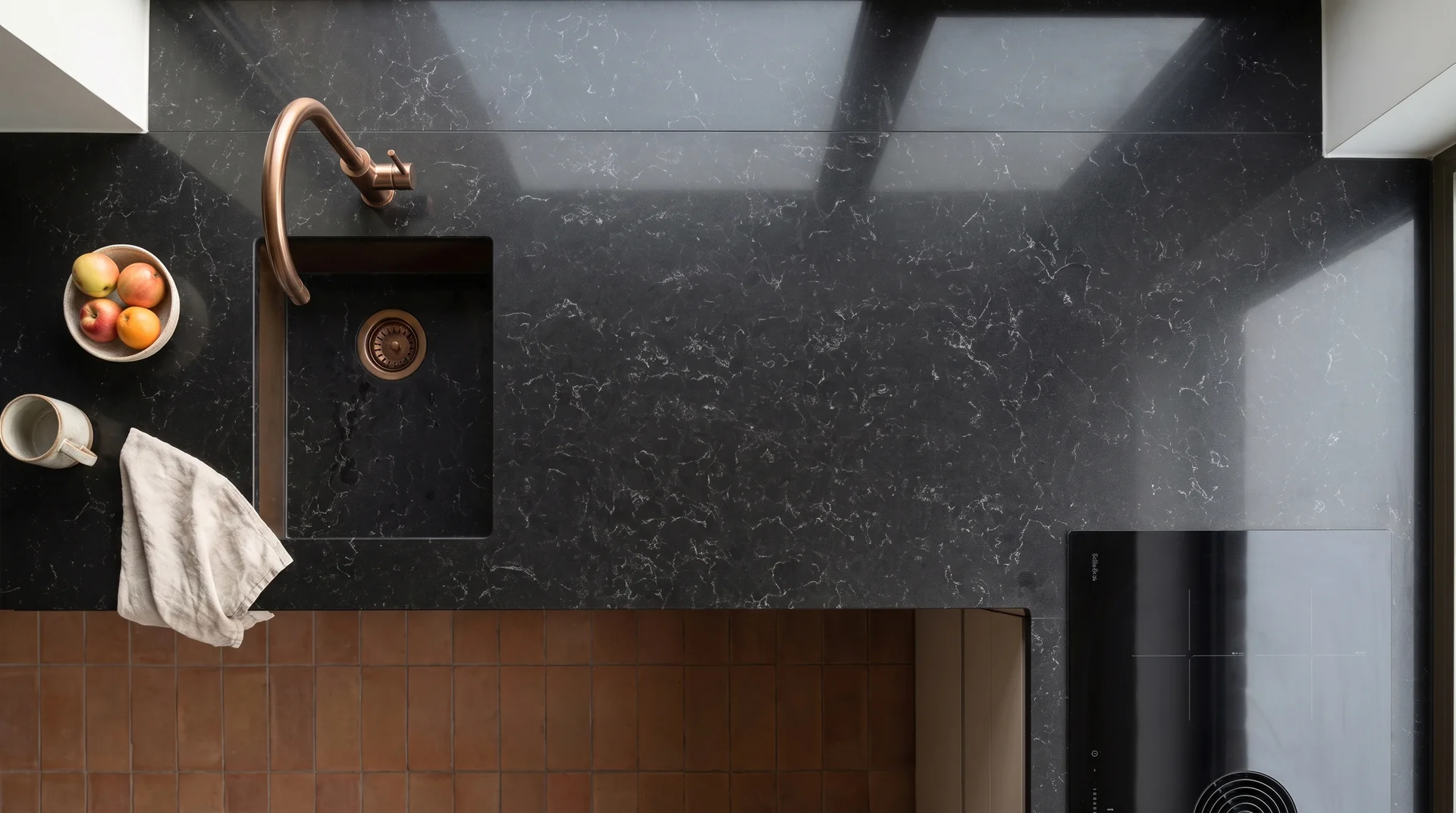 Carrara Noir quartz worktop shown from an overhead kitchen view