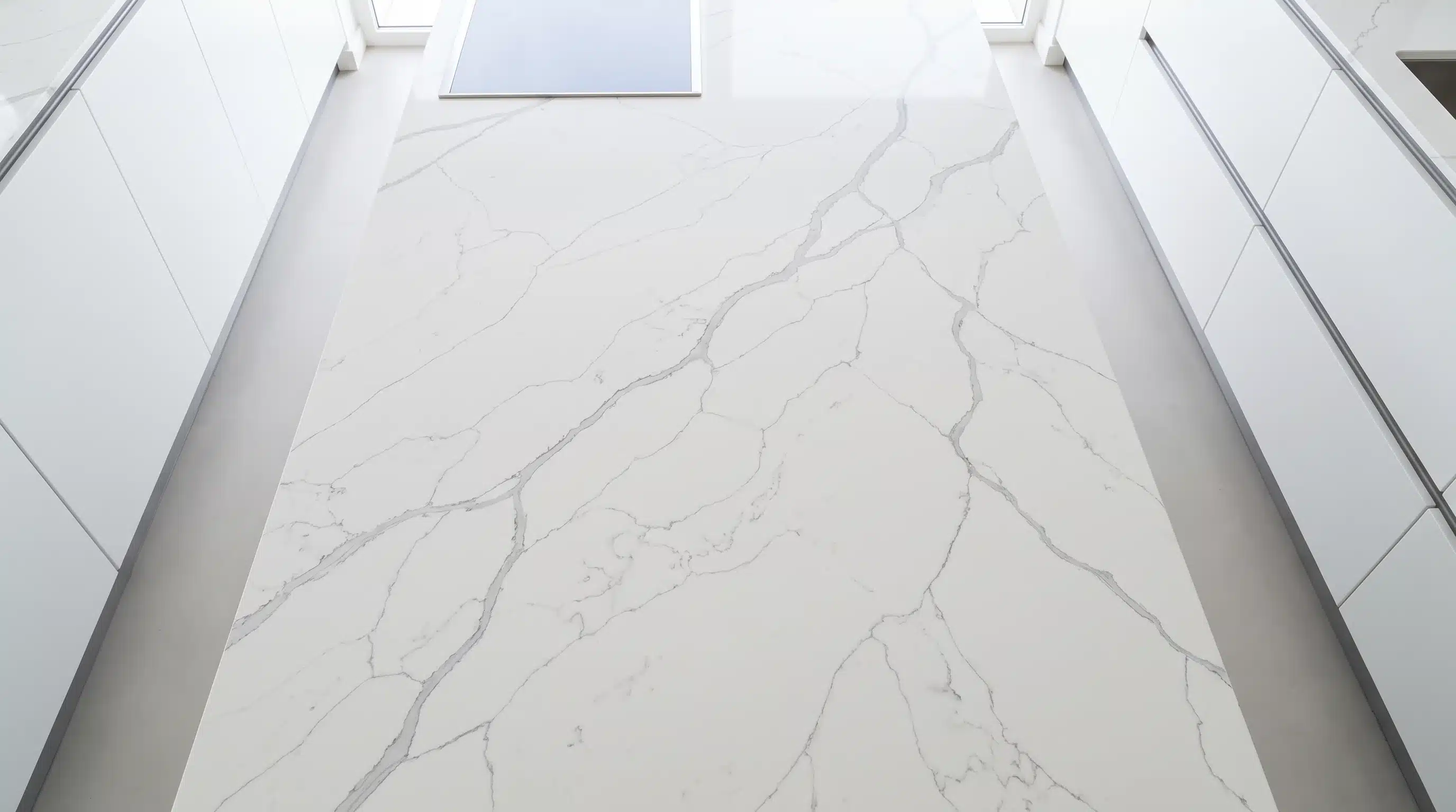 Overhead view of Statuario Venato CQM427 quartz worktop in a fitted kitchen